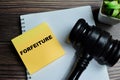 Concept of forfeiture write on sticky notes isolated on Wooden Table Royalty Free Stock Photo