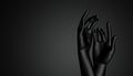 The concept of fragility and openness of women. Beautiful black hands on black background. Hands palms forward.