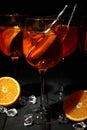 Concept of fresh summer cocktail, Aperol Spritz on wooden table against dark background Royalty Free Stock Photo