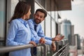 Two colleagues talking on balcony of work office Royalty Free Stock Photo