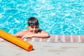 Oudoor summer activity. Concept of fun, health and vacation. A happy boy eight years old in swimming goggles is holding Royalty Free Stock Photo