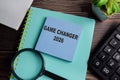 Concept of game changer 2026 write on sticky notes isolated on Wooden Table Royalty Free Stock Photo