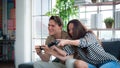 Concept, game or e-sport. Couple or lover playing games. happily Two people looking at a computer monitor or TV screen. Young man Royalty Free Stock Photo