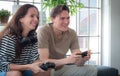 Concept, game or e-sport. Couple or lover playing games. happily Two people looking at a computer monitor or TV screen. Young man Royalty Free Stock Photo