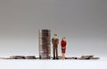 Miniature people and coins. Royalty Free Stock Photo