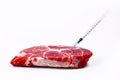 Concept for genetically modified animals or antibiotics and medicine residue in food with raw red meat with injected syringe