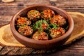 The concept of Georgian cuisine. Baked mushrooms champignons with meat and cilantro. Serving dishes in a restaurant in a plate