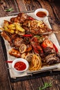 Concept of Georgian cuisine. Large meat board with shashlik, roasted meat, french fries, roast lamb and sauce. Serving dishes