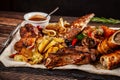 Concept of Georgian cuisine. Large meat board with shashlik, roasted meat, french fries, roast lamb and sauce. Serving dishes Royalty Free Stock Photo