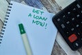 Concept of Get A Loan Now! write on sticky notes isolated on Wooden Table Royalty Free Stock Photo