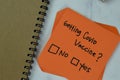 Concept of Getting Covid Vaccine? No or Yes write on sticky notes isolated on Wooden Table Royalty Free Stock Photo