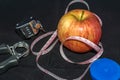 Concept - Getting in Shape. Closeup on Measuring Tape and Apple