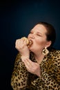 The concept of gluttony. Overweight. Fat woman does not eat hamburger appetizingly.