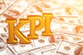 Concept gold abbreviation of KPI - Key Perfomance Indicator standing or lying on banknotes background. 3D Render.