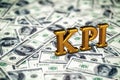 Concept gold abbreviation of KPI - Key Perfomance Indicator standing or lying on banknotes background. 3D Render.