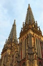 Concept of Gothic style in architecture. Amazing decorated top of the two towers. The Saint Nicholas Roman Catholic Cathedral Royalty Free Stock Photo