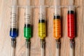 Concept graphics of virus infection from multi-colored syringes. Graphics of the virus epidemic COVID Royalty Free Stock Photo