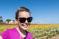 Brunette caucasion adult woman smiles in a field of flowers in California Royalty Free Stock Photo