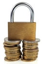 Padlock on stacks of coins close up on white background Royalty Free Stock Photo