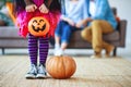 Concept of Halloween. child girl legs in witch costume with pumpkin Royalty Free Stock Photo