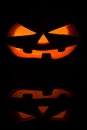 The concept of Halloween. Evil scary pumpkin in the dark with re Royalty Free Stock Photo