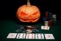 The concept of Halloween. Evil scary pumpkin plays poker. Jack L