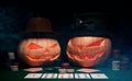 The concept of Halloween. Evil scary pumpkins play poker in hats