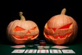 The concept of Halloween. Evil scary pumpkins play poker. Jack L