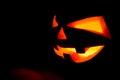 The concept of Halloween. The ghastly, ghastly pumpkin glows wit Royalty Free Stock Photo