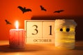 The concept for Halloween. Mummy from a can, gauze and candles, a wooden calendar showing October 31.