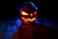 The concept of Halloween. Pumpkin jack Lamp, in headphones with Royalty Free Stock Photo