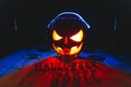 Concept of Halloween. Pumpkin jack Lamp, in headphones with CDs Royalty Free Stock Photo