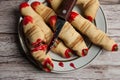 Terrible and delicious cookies `witch`s finger`, a knife in the blood in a plate on a wooden background.