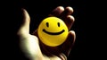 The concept of happiness, emoji smiles in the palms, dark background. AI generated. Royalty Free Stock Photo