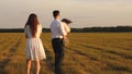 Concept of a happy childhood. child, dad and mom play in the meadow in the sun. mother, father and little daughter Royalty Free Stock Photo