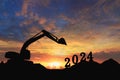 Concept happy new year 2024,crawler excavator silhouette