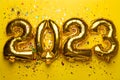 2023 Happy New Year concept from golden foil balloon