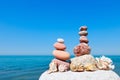 Concept of harmony and balance. double Rock Zen and shells on the background of summer sea Royalty Free Stock Photo