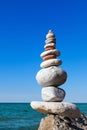 Concept of harmony and balance. Rock Zen on the background of summer sea Royalty Free Stock Photo