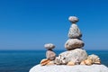 Concept of harmony and balance. Rock Zen of seashells on a background of summer sea. Royalty Free Stock Photo