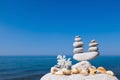 Concept of harmony and balance. Rock Zen of seashells on a background of summer sea. Royalty Free Stock Photo