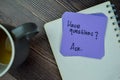 Concept of Have Questions? Ask write on sticky notes isolated on Wooden Table