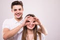 Concept of having funtime and grimacing, behaving like kids. Close up photo of two happy people making binoculars with their hands Royalty Free Stock Photo