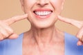 Concept of having strong healthy straight white perfect teeth at old age. Cropped portrait of beaming smile female Royalty Free Stock Photo