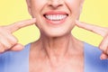 Concept of having strong healthy straight white perfect teeth at old age. Cropped portrait of beaming smile female Royalty Free Stock Photo