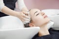 Concept head massage. Beautiful blond woman getting hair wash in beauty salon Royalty Free Stock Photo