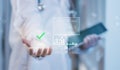 Concept healthcare data compliance and quality assurance doctor presenting virtual check icon and analytics dashboard, symbolizing Royalty Free Stock Photo
