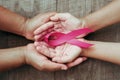 concept healthcare and medicine. hand holding pink ribbon on wood. breast cancer awareness. sign of hope Royalty Free Stock Photo