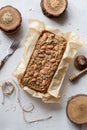 Concept of healthy clean eating. Wholegrain gluten free sugar free cake with almonds, flax and amaranth seeds in baking paper on