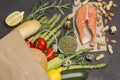 Concept of healthy eating and longevity. Food sources of omega 3, protein. Paper bag with salmon leavy vegetables, beans nuts, Royalty Free Stock Photo